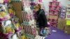 FILE - A shopper picks a present at a store selling discount toys in Madrid on Dec. 17, 2010. 