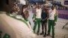 Niger delegation members pose with one of their wrestlers, center, who won a bout at the 9th Francophone Games in Kinshasa, July 30, 2023. Because of the July 26 military coup in Niamey, some members of the Niger delegation were unable to reach Kinshasa.