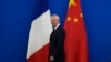French Finance Minister Bruno Le Maire walks past the French and Chinese flags at the 9th China-France High Level Economic and Financial Dialogue held at the Diaoyutai State Guest House in Beijing, July 29, 2023. 