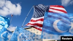 Flags fly during a rally for the Uyghur people of China in Washington on Nov. 28, 2022. The U.S. added more China-based companies to a blacklist on Aug. 1, 2023, barring their goods from entering the United States as a measure against forced labor.
