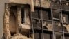 A person looks out of a damaged building in Kyiv, Ukraine, on Aug. 2, 2023, following Russian drone attacks. Britain on Aug. 8, 2023, imposed sanctions on an Iranian drone maker and other foreign businesses, accusing them of supplying Russia with weapons.