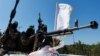 Palestinian fighters from the armed wing of Hamas take part in a military parade to mark the anniversary of the 2014 war with Israel, near the border in the central Gaza Strip, July 19, 2023. 
