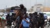 FILE - Angolan police officers look on in Luanda on Feb. 4, 2021 during a demonstration against police brutality, days after several separatists were killed in a thwarted protest in the country's northeast. 