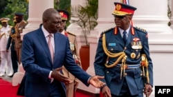 FILE - Chief of Kenya Defense Forces General Francis Ogolla (R) speaks to Kenyan President William Ruto as they prepare to receive Britain's King Charles III and Queen Camilla during the ceremonial welcome at the State House in Nairobi on Oct. 31, 2023.