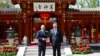 In this photo released by Xinhua News Agency, Chinese President Xi Jinping, right and German Chancellor Olaf Scholz pose in Beijing, China, April 16, 2024.