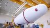 This handout photograph taken and released by the Russian Space Agency Roscosmos on August 7, 2023, shows technicians finishing to assemble a Soyuz 2.1b rocket carrying the Luna-25 lander ahead of its launch scheduled for August 11, 2023.