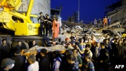 Rescue personnel recover the body of victim from under the rubble of a collapsed building in Tehran, Aug. 6, 2023.