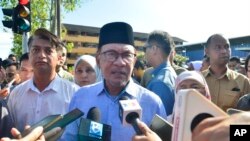 Malaysian Prime Minister Anwar Ibrahim speaks to media after he cast his ballot during the election at a polling station in Seberang Perai, Penang state, Malaysia, Aug. 12, 2023. 