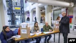This handout picture released by the Argentinian Presidency shows President Alberto Fernandez casting his vote during primary elections at a polling station in Buenos Aires, Aug. 13, 2023. (Photo by Esteban Collazo / Argentinian Presidency / AFP)