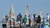 Tourists walk toward St. Mark's Square in Venice, July 31, 2023. UNESCO is recommending that Venice be placed on the list of World Heritage in Danger, as "insufficient" measures have been taken to protect the city against tourism and climate change.