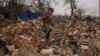 Mariya, a local resident, looks for personal items in the rubble of her house, destroyed during fighting between Russian and Ukrainian forces in the village of Yasnohorodka, on the outskirts of Kyiv, Ukraine, March 30, 2022.