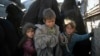 Women and children exit the back of a truck as they arrive at a U.S.-backed Syrian Democratic Forces (SDF) screening area after being evacuated out of the last territory held by Islamic State militants, in the desert outside Baghuz, Syria, March 1, 2019. 