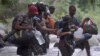 FILE - Haitian migrants cross the jungle of the Darien Gap, near Acandi, Choco department, Colombia, heading to Panama, on Sept. 26, 2021, on their way toward the United States.