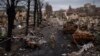 A Ukrainian serviceman walks amid destroyed Russian tanks in Bucha, on the outskirts of Kyiv, Ukraine, April 6, 2022. 