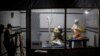 FILE - Health workers treat an unconfirmed Ebola patient inside a MSF (Doctors Without Borders)-supported Ebola Treatment Center (ETC) in Butembo, Democratic Republic of Congo, Nov. 3, 2018.