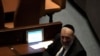 FILE - Israeli lawmaker Aryeh Deri visits with a colleague during a vote on Levin as Speaker of the Knesset, Israel's parliament, in Jerusalem, Dec. 13, 2022. 