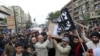 Lebanese Sunnis march through the northern city of Tripoli carry the coffins of Lebanese militants killed in Syria last December. Sunni militants from Lebanon have been fighting with rebels trying to oust Syria's Assad government. 