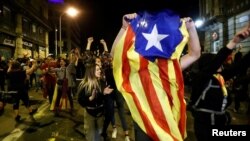 Demonstrators celebrate after police leave the area during a protest after a verdict in a trial over a banned independence referendum in Barcelona, Spain, Oct. 20, 2019. 