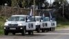 United Nations peacekeepers put on protective gear before driving through the Kuneitra border crossing between Israel and Syria, in the Israeli occupied Golan Heights, March 8, 2013.