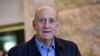 Former Israeli Prime Minister Ehud Olmert speaks to the press in the Supreme Court after the court reduced his sentence from six years to 18 months in prison in the Holyland corruption case in Jerusalem, Dec. 29, 2015.