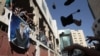 Palestinian protesters throw shoes at a banner of Prime Minister Salam Fayyad during a demonstration in the West Bank city of Hebron September 10, 2012. 