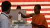 Cambodian Buddhist monk, right, casts his ballot in local elections at Wat Than pagoda's polling station in Phnom Penh, file photo. 