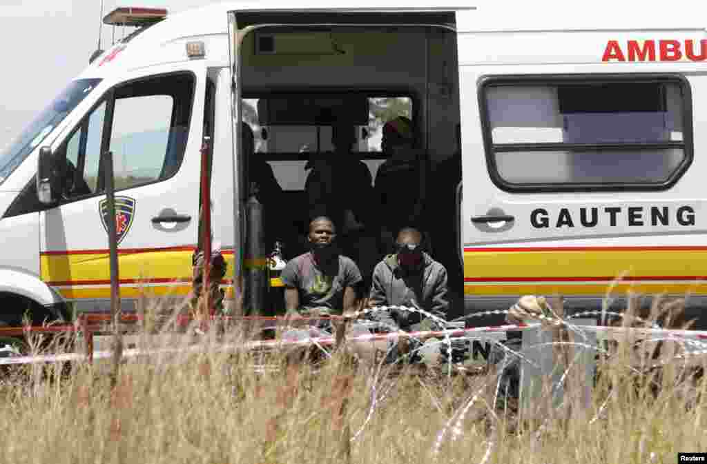Suspected illegal miners await treatment after emerging from an abandoned gold shaft in Benoni, east of Johannesburg, South Africa, Feb. 17, 2014. 
