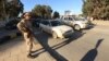 A security officer patrols the city ahead of Libya's two-year anniversary marking the ouster of Moammar Gadhafi, Benghazi, Feb. 12, 2013.