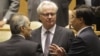 Syria's U.N. Ambassador Bashar Ja'afari (L), speaks to Russia's U.N. Ambassador Vitaly Churkin (C), and China's deputy U.N. Ambassador Wang Min before the United Nations General Assembly passed a draft resolution condemning Syria, at the United Nations in