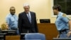 FILE - Former Bosnian Serb leader Radovan Karadzic enters the courtroom on the first day of his defense against war crime charges at the International Criminal Tribunal for the Former Yugoslavia in The Hague, Oct. 16, 2012. 