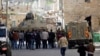Israeli security forces stand guard as Jewish settlers are forced out of two homes in the West Bank city of Hebron, Jan. 22, 2016.