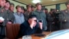 Picture released by North Korea's official KCNA news agency in Pyongyang Mar. 14, 2013 shows North Korean leader Kim Jong-un (C) and military officers watching a live shell firing drill.