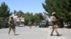 FILE - Afghanistan, security forces take position during a fighting outside a government compound in the city of Lashkar Gah, capital of Helmand province, Afghanistan, May. 13, 2015. 