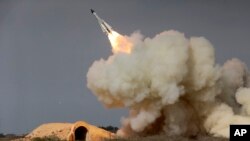 FILE - In this Dec. 29, 2016, file photo, released by the semiofficial Iranian Students News Agency (ISNA), a long-range S-200 missile is fired in a military drill in the port city of Bushehr, on the northern coast of Persian Gulf, Iran.