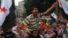Lebanese and Syrian citizens celebrate as they wave flags of the Syrian opposition and the Islamist party Hizb Ut-Tahrir, in Tripoli, northern Lebanon, July 18, 2012.