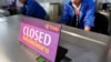 FILE - Airport staff inspect the ticketing counter at the Suvarnabhumi international airport in Bangkok.