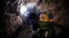 Palestinian worker moves goods through a smuggling tunnel between the Gaza Strip and the Egyptian Sinai February 19, 2013. The tunnel was flooded by Egyptian forces last month to stop the smuggling.