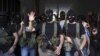 Shi'ite masked gunmen from the Mekdad clan gather at the Mekdad family's association headquarters in the southern suburbs in Beirut, Lebanon, August 15, 2012.