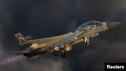 FILE - An Israeli Air Force F-15 fighter jet flies during an aerial demonstration at the Hatzerim air base in southern Israel, June 30, 2016.