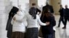 Israeli women, friends and relatives of two Jewish citizens who, according to Israel Radio, were indicted for a July 31 arson attack, walk together outside a courtroom at the District court in Lod, central Israel, Jan. 3, 2016.