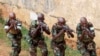 FILE - Somali government soldiers demonstrate their skills during their passing out ceremony at an army training camp in Uganda, Feb. 1, 2013. 