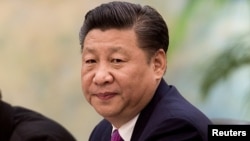 China's President Xi Jinping looks on during a meeting with Laos' Prime Minister Thongloun Sisoulith in Beijing, China, Dec. 1, 2016. 