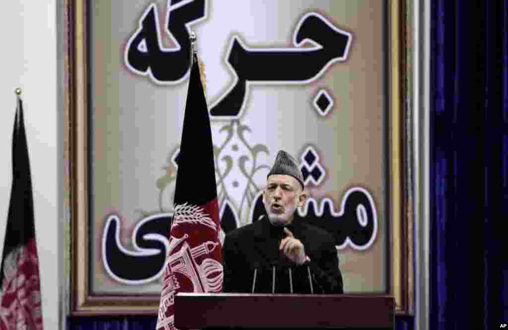 Afghan President Hamid Karzai speaks during the first day of the Loya Jirga in Kabul, Nov. 21, 2013. 
