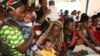 Women and their children visit a clinic at Sinza Health Centre in Tanzania's capital Dar es Salaam May 2, 2011. 