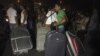 Passengers carrying their baggage try to pass, after the main road leading to Beirut airport was blocked by relatives of the 11 Lebanese Shi'ite pilgrims that were abducted in Syria, August 15, 2012. 