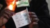 An electoral officer shows a ballot for House of Assembly candidates as the country went to the polls in a Harare suburb, July 31 2013. 