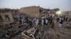 FILE - Afghan civil society members light candles during a vigil for victims of recent attacks at the site of a truck bombing in Kabul, Aug. 8, 2015.
