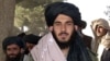 FILE - Tayyab Agha, the special assistant to Mullah Mohammad Omar, walks to a press conference in Spin Boldak, November 21, 2001.