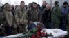 FILE - Fellow Ukrainian government soldiers and mourners bid farewell to Oleksandr Ilnitsky, who was shot dead by a pro-Russian rebel sniper in Ukraine's eastern Donetsk region, during a service in Kyiv's Independence Square, Jan. 11, 2016.