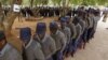 Zimbabwean police officers wait in line to cast their votes at a polling station in Harare, July 15, 2013. Early voting started for police and security personnel who will be on duty during the nation's July 31elections. 